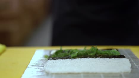 A-cook-is-about-to-prepare-a-sushi-roll-with-seaweed-and-mussels