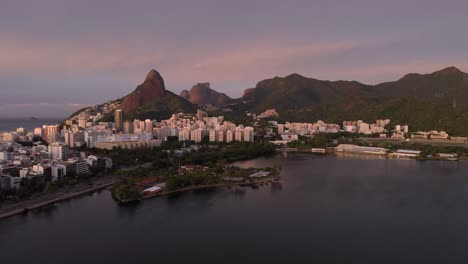 Slow-panning-around-the-city-lake-of-Rio-de-Janeiro-with-the-beach-neighbourhoods-of-Ipanema-and-Leblon-turning-to-the-Two-Brothers-Peak-and-Gavea-Rock-landmarks-part-of-the-Tijuca-National-Parque
