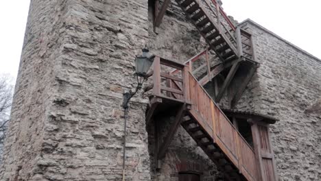 View-from-the-ground-of-the-medieval-fortification-wall-and-old-staircase-made-in-wood-in-Tallinn-old-town