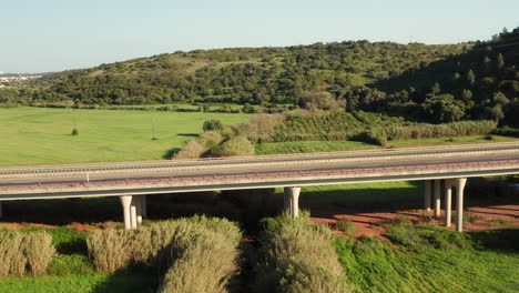 Aerial:-A-highway-going-through-the-country-side-of-the-Algarve-in-Portugal