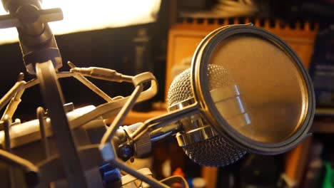 Slow-panning-right-shot-of-close-up-studio-mic-in-production-room