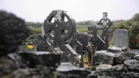 Old-Tombstones-in-Shape-of-Crosses-in-the-Pouring-Rain-in-a-Cemetery-on-a-Cloudy-Day