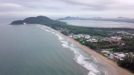 aerial-shot-over-coastline-with-visible-mountains-and-shore-in-the-background,-Thailand