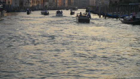 Sunset-in-grand-canal,boats-and-gondolas,-Venice,-Italy