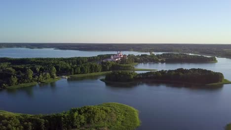 aerial-shot-over-many-small-lakes-and-closing-in-to-a-church-in-the-distance