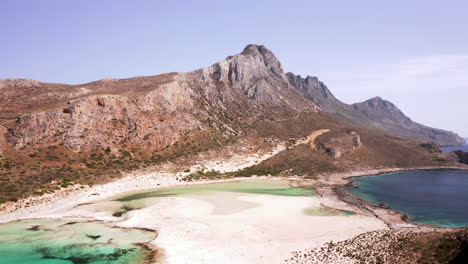 Aerial-Dolly-Shot-of-Balos-Beach-Moving-Across-the-Lagoon-towards-the-Mountains-on-Beautiful-Sunny-Day