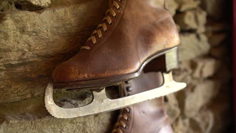 SLOWMO---Old-brown-leather-antique-ice-skating-shoe-on-historic-wall