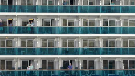 Cruiseship-passangers-watching-departure-form-ship-balconies