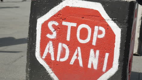 Stop-Adani-protest-sign-painted-on-the-bollards-in-Melbourne,-Australia