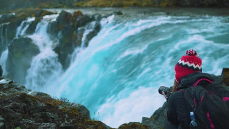Photographer-woman-at-Midfoss-falls,-Iceland