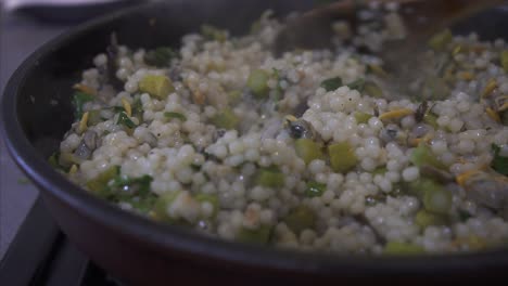 Mixing-a-hot-pan-of-vegetarian-Couscous