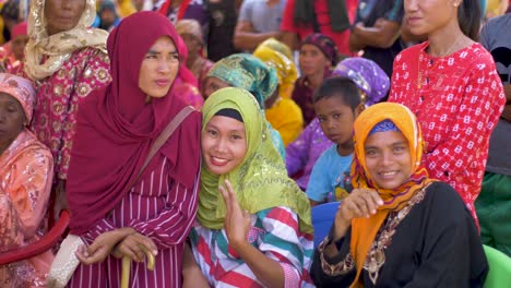 Young-Muslim-girls-dressed-in-bright-clothing-smile-as-they-attend-an-event-as-part-of-National-Women's-Month-being-celebrated-in-the-Autonomous-Region-in-Muslim-Mindanao,-ARMM,-Philippines