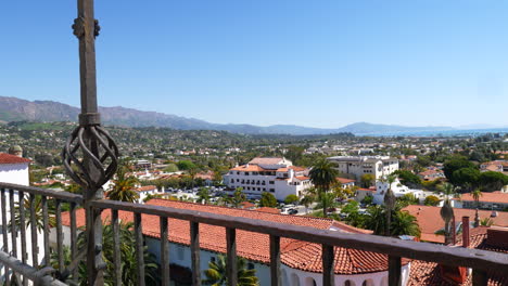 Looking-down-on-the-view-of-Spanish-roof-architecture-and-city-buildings-leading-out-to-the-ocean-in-downtown-Santa-Barbara,-California