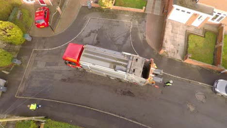 Aerial-View-of-Dustmen-putting-recycling-waste-into-a-waste-truck,-Bin-Men,-Recycling-day,-refuse-collection-in-Stoke-on-Trent,-Staffordshire