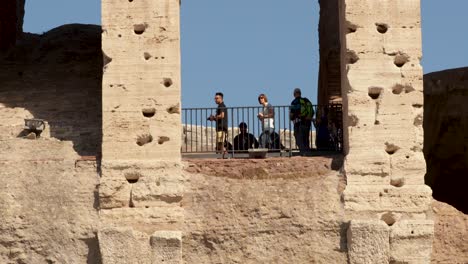 Tilt-close-shot-for-Tourists-taking-photos-from-the-arch-of-the-Colosseum