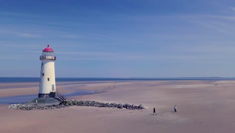 Drone-footage-showing-Point-of-Ayr-Lighthouse,-Talacre-Beach,-North-Wales,-UK