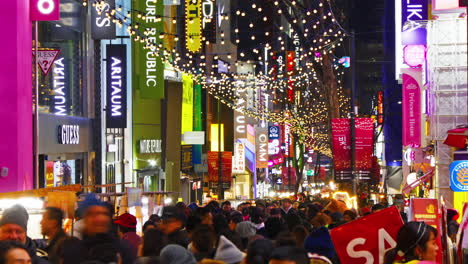 Seoul-South-Korea,-Circa-December-2018-Time-lapse-of-the-colorful-illuminated-Myeongdong-street-market-in-Seoul-with-lots-of-people-in-it
