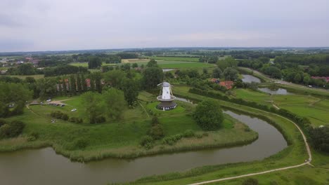 Aerial-shot-of-the-historical-town-of-Veere,-with-an-old-windmill-in-frame