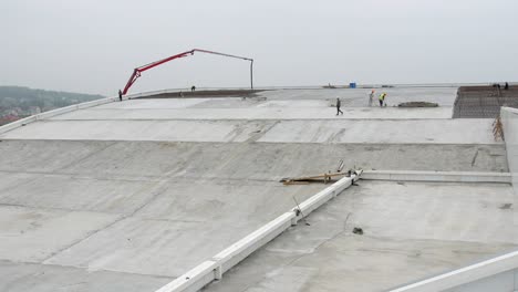 Panning-view-of-construction-on-the-rooftop-of-a-industrial-factory-job-site