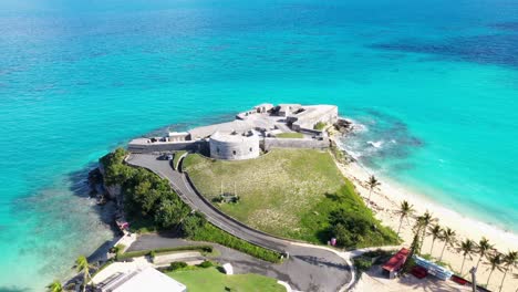 Aerial-view-of-old-fort-on-tropical-island-overlooking-turquoise-ocean