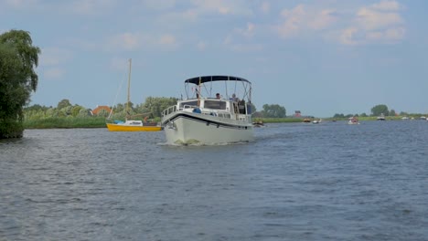 Dutch-Motor-yacht-is-sailing-through-the-canal-in-The-Netherlands-in-slow-motion-in-the-summer