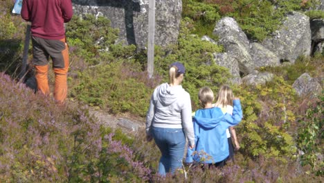 Family-hiking,-rocky-archipelago-trail