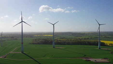 a-drone-flight-over-fields-in-spring-and-windmills