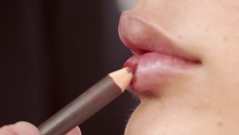 applying-red-lipstick-on-beautiful-lips