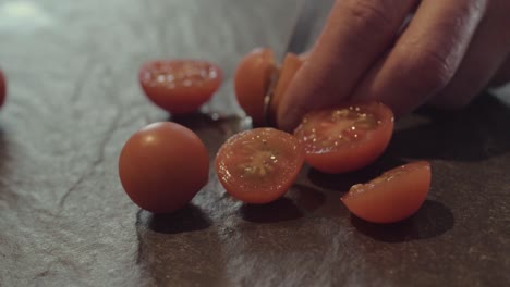 Slicing-cherry-tomatoes-on-slate