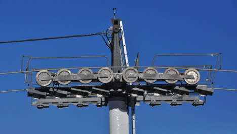 Close-up-time-lapse-of-a-ski-lift-pole-with-the-wheels-going-around-in-the-Alps