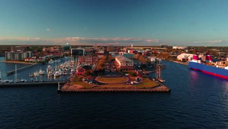 A-drone-shot-starting-over-the-water-flying-down-a-small-harbor-Main-Street