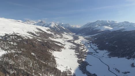 Aerial-landscape-of-a-village-of-Livigno-in-Italy,-placed-in-alpine-valley-between-high-and-steep-mountains