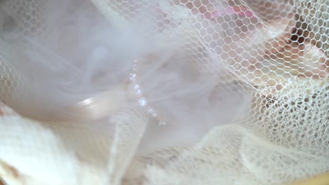 Smoke-blowing-on-macro-wedding-rings-in-slow-motion