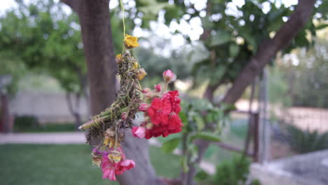 CLOSE-UP-Footage-of-mayflowers-bouquet,-hanging-and-blowing-in-the-wind