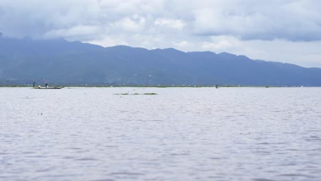 Boating-across-Inle-Lake,-Myanmar-in-cloudy-conditions