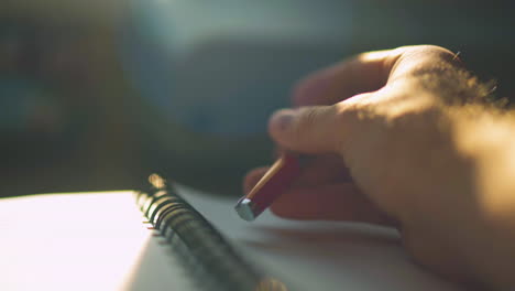 Close-up-of-a-man's-hand-trying-to-write-something,-tapping-the-pen-and-then-putting-pen-down