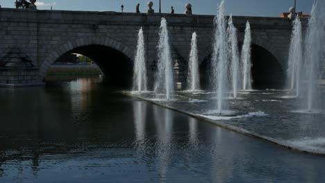 Waterjets-fountain-in-the-city-near-a-stone-bridge