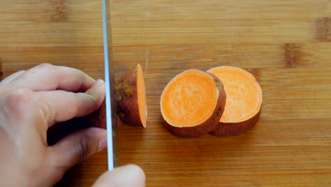Person-cut-up-pieces-of-sweet-potato