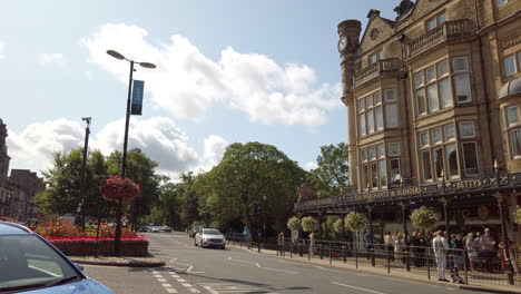 Pan-Reveal-Shot-of-Bettys-Tea-Room-in-Harrogate-with-Traffic-Passing-By