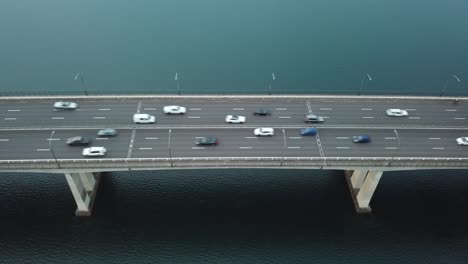 Aerial:-Stationary-drone-shot-of-vehicles-driving-across-Captain-Cook-bridge-in-Sydney,-NSW