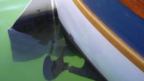 The-view-of-an-underwater-propeller-from-a-boat-that-is-parking-in-a-marina