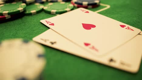 Two-Aces-Thrown-on-Green-Casino-Table---Chips-Checks-Casino-Token--Poker---Extreme-Close-Up---Slow-Motion