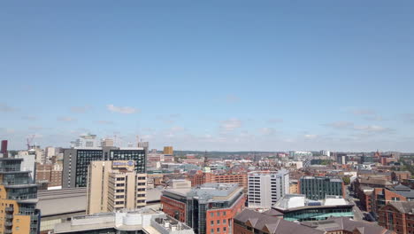 Right-to-Left-Pan-of-Leeds-City-Centre-Skyline-including-Leeds-Station---Granary-Wharf-on-a-Beautiful-Summer’s-Day-with-Blue-Sky