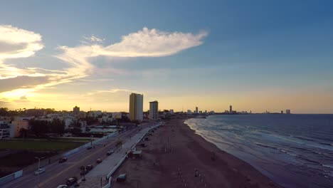 aerial-view-over-the-beach-of-Boca-del-Rio,-Veracruz,-with-a-spectacular-sunset