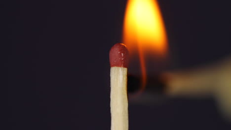 Hand-igniting-matches-close-up-macro-shot-captured-in-front-of-black-background-in-slow-motion-at-120-fps