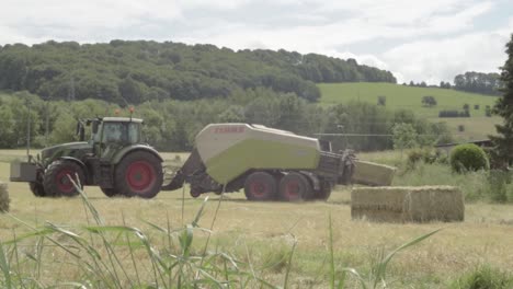 Tractor-in-hay-fields-pulling-a-baler