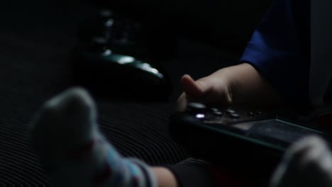 young-child-boy-toddler-with-controller-playing-electronic-TV-video-games-on-sofa-wearing-fireman-pants-socks-jersey-new-generation-technology-hand–eye-coordination-skills-gaming-adiction