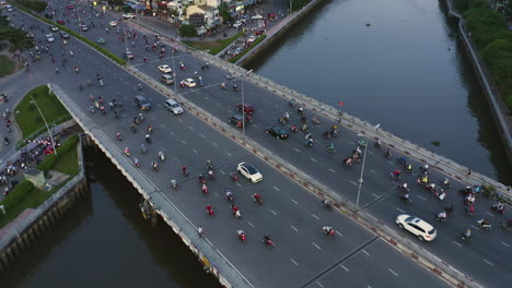 Hi-aerial-view-of-evening-traffic-over-Dien-Bien-Phu-Bridge,-Binh-Thanh-district,-Ho-Chi-Minh-City,-Vietnam-which-crosses-the-Hoang-Sa-canal