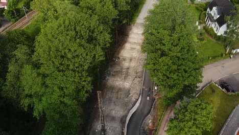 Aerial-footage-showing-construction-of-a-the-road-delsjovagen-in-Gothenburg,-Sweden