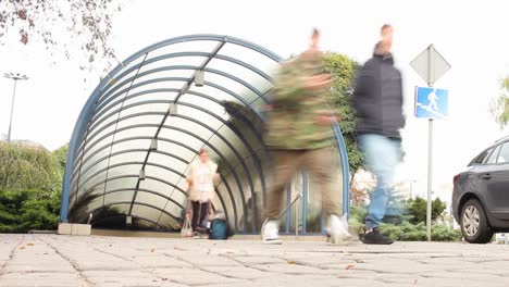 A-Time-lapse-of-People-Walking-In-and-Out-of-a-Bydgoszcz-Subway-Entrance-in-Poland-on-a-cloudy-day